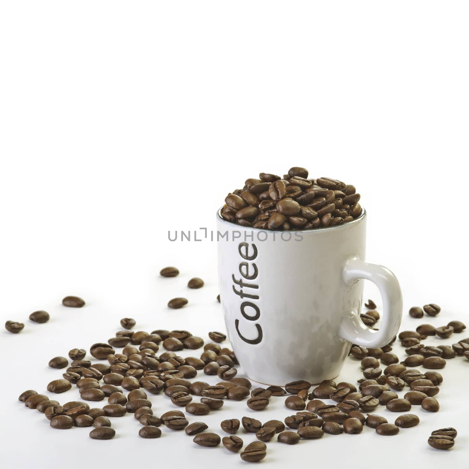 Cup full of Coffee beans with white background.