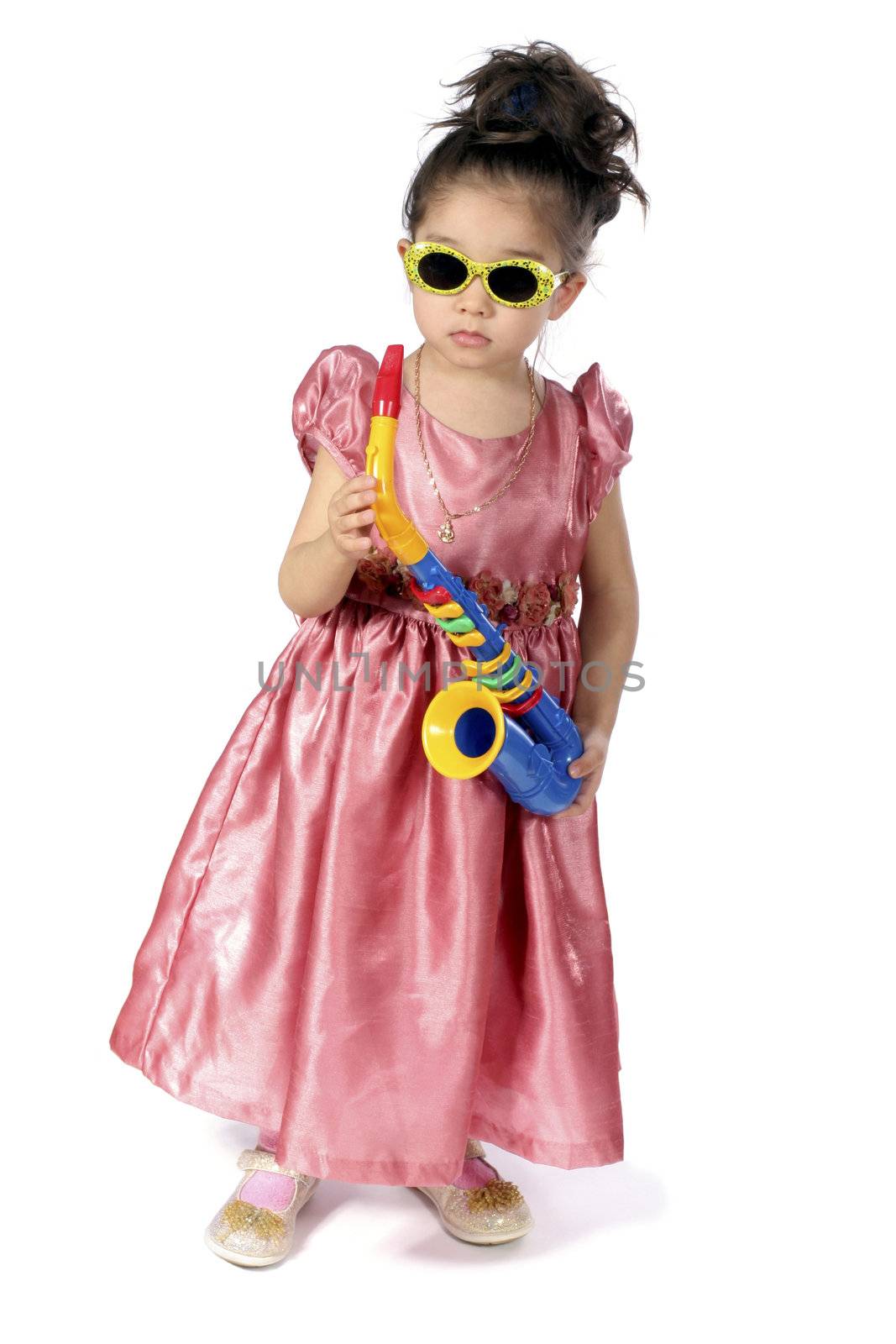 Small girl sun-protective spectacles with saxophone in hand