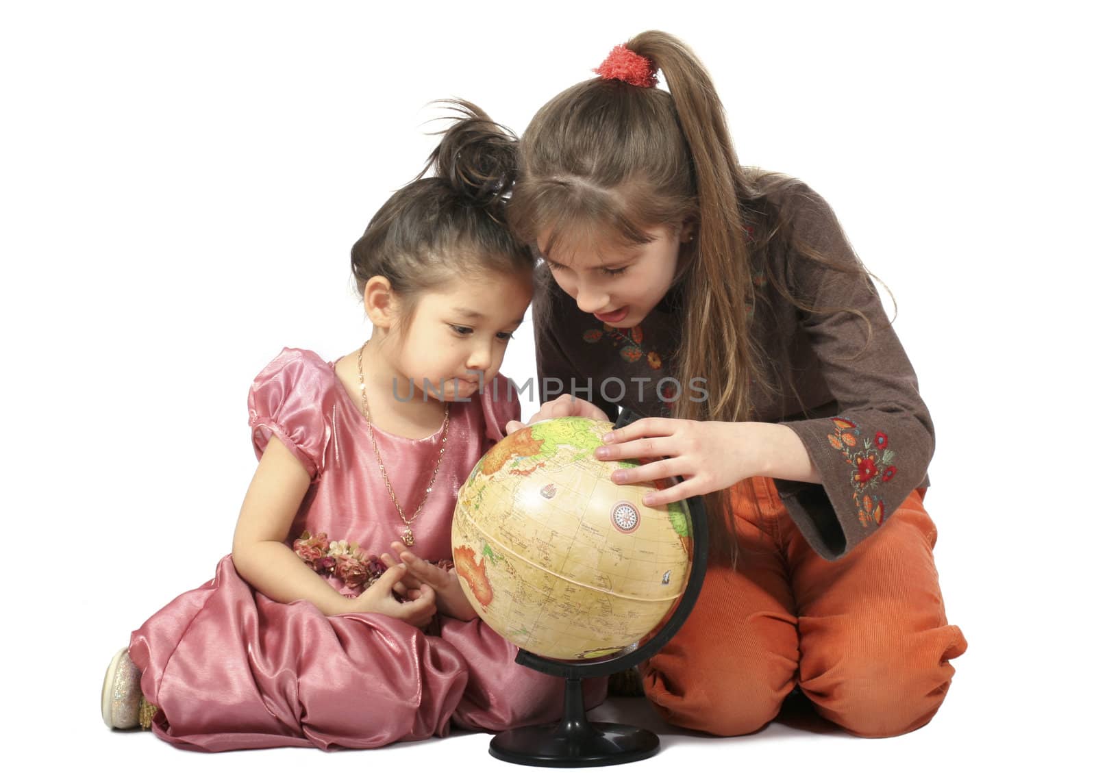Two girls with long hair slavonic and asiatic appearance consider globe. Isolated