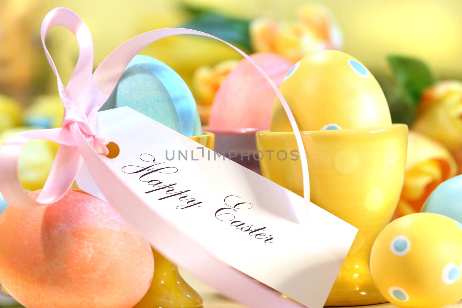 Festive decorations and eggs with card that reads Happy Easter