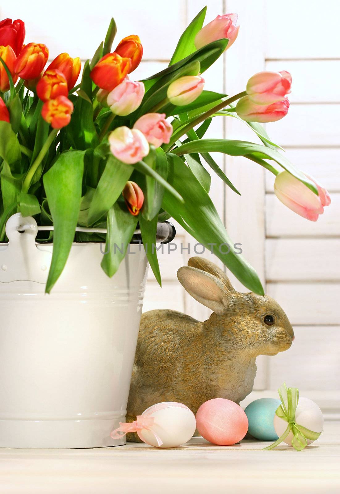 Pot of tulips with rabbit on the counter