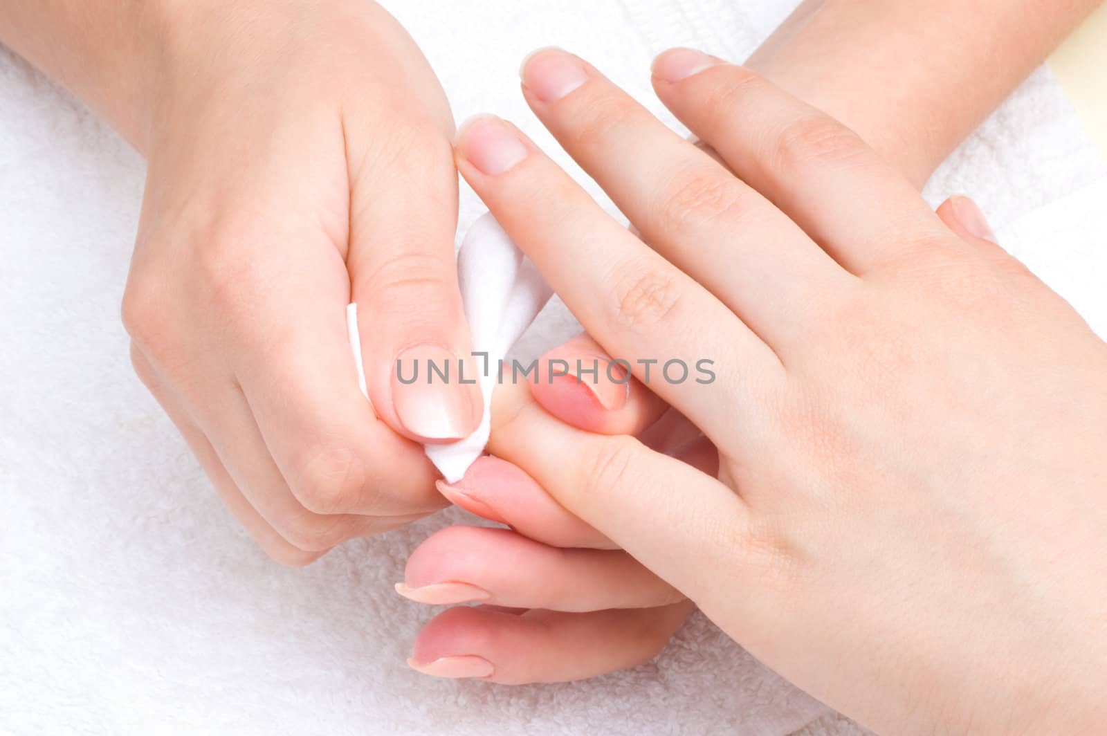 manicure applying - wiping the mosturizer from end of fingers