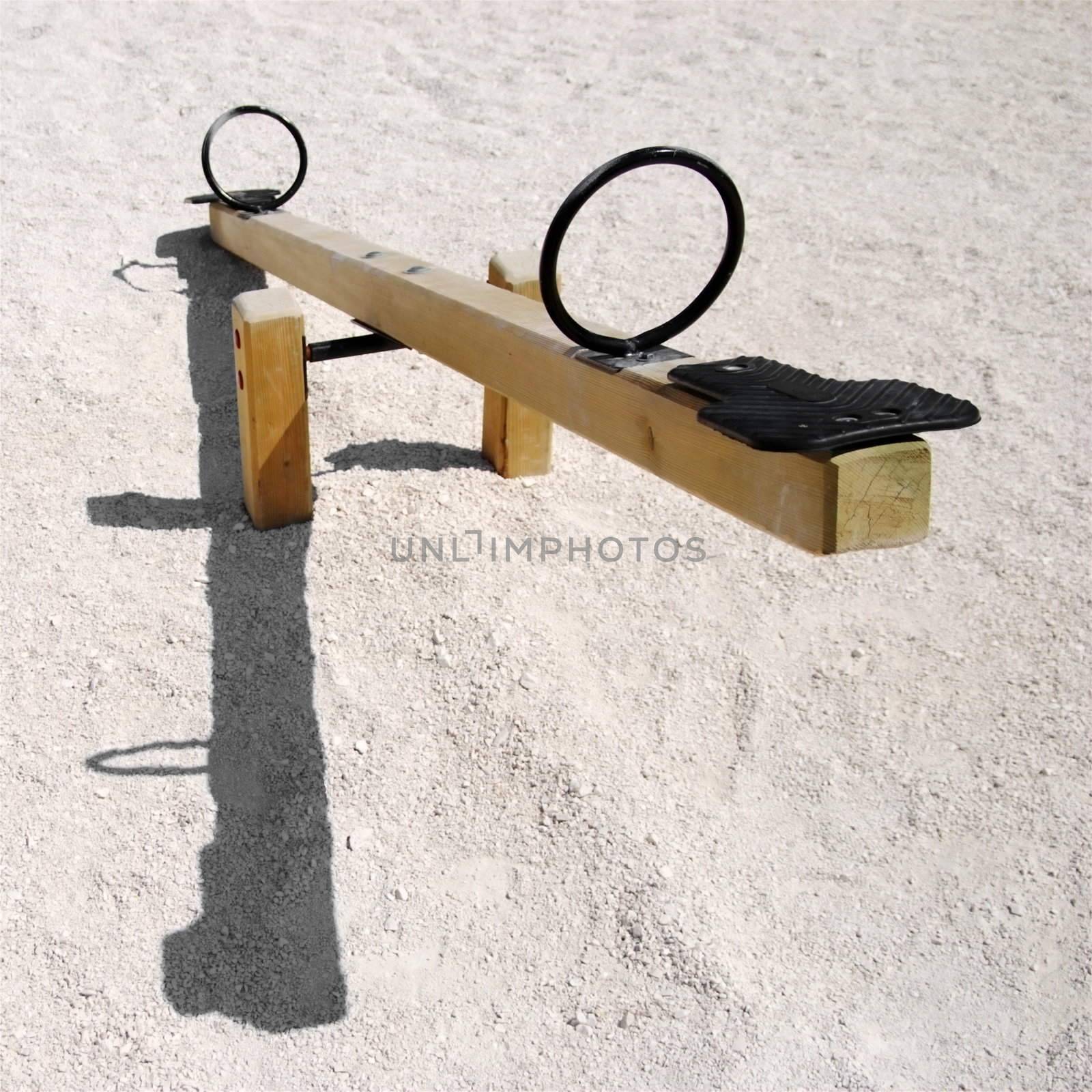 empty wooden teeter-totter or seesaw with shadow - negative natality concept