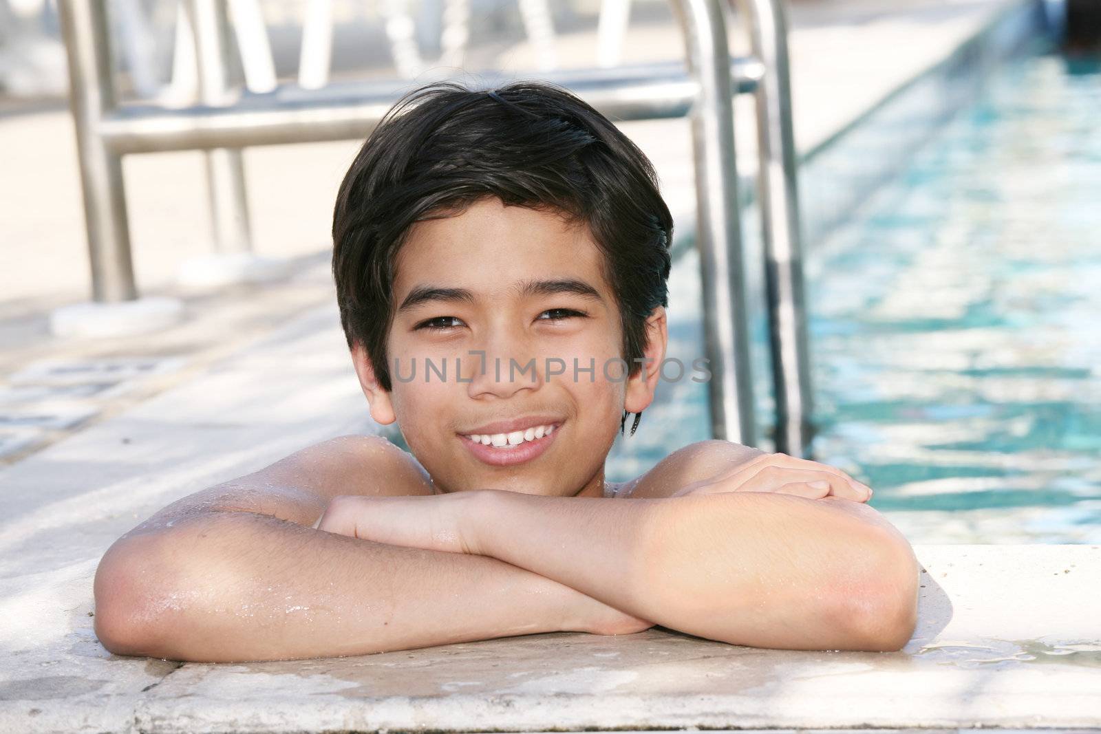 Young boy relaxing  in the pool