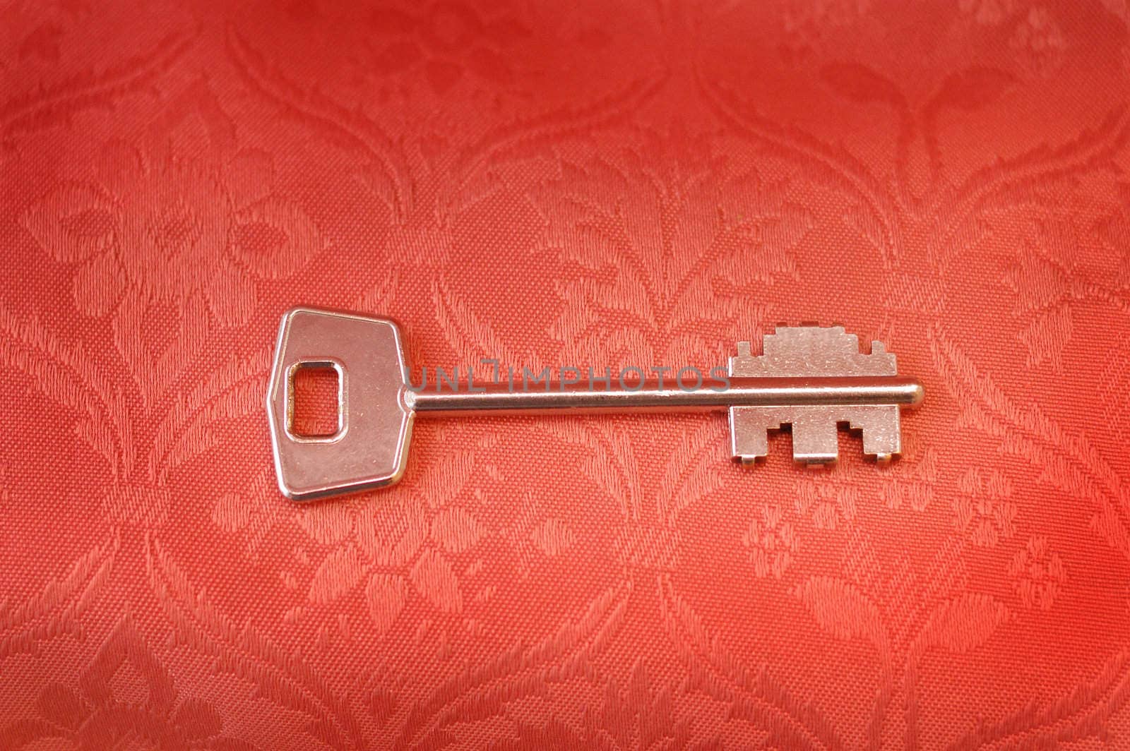 antique key on old textile background