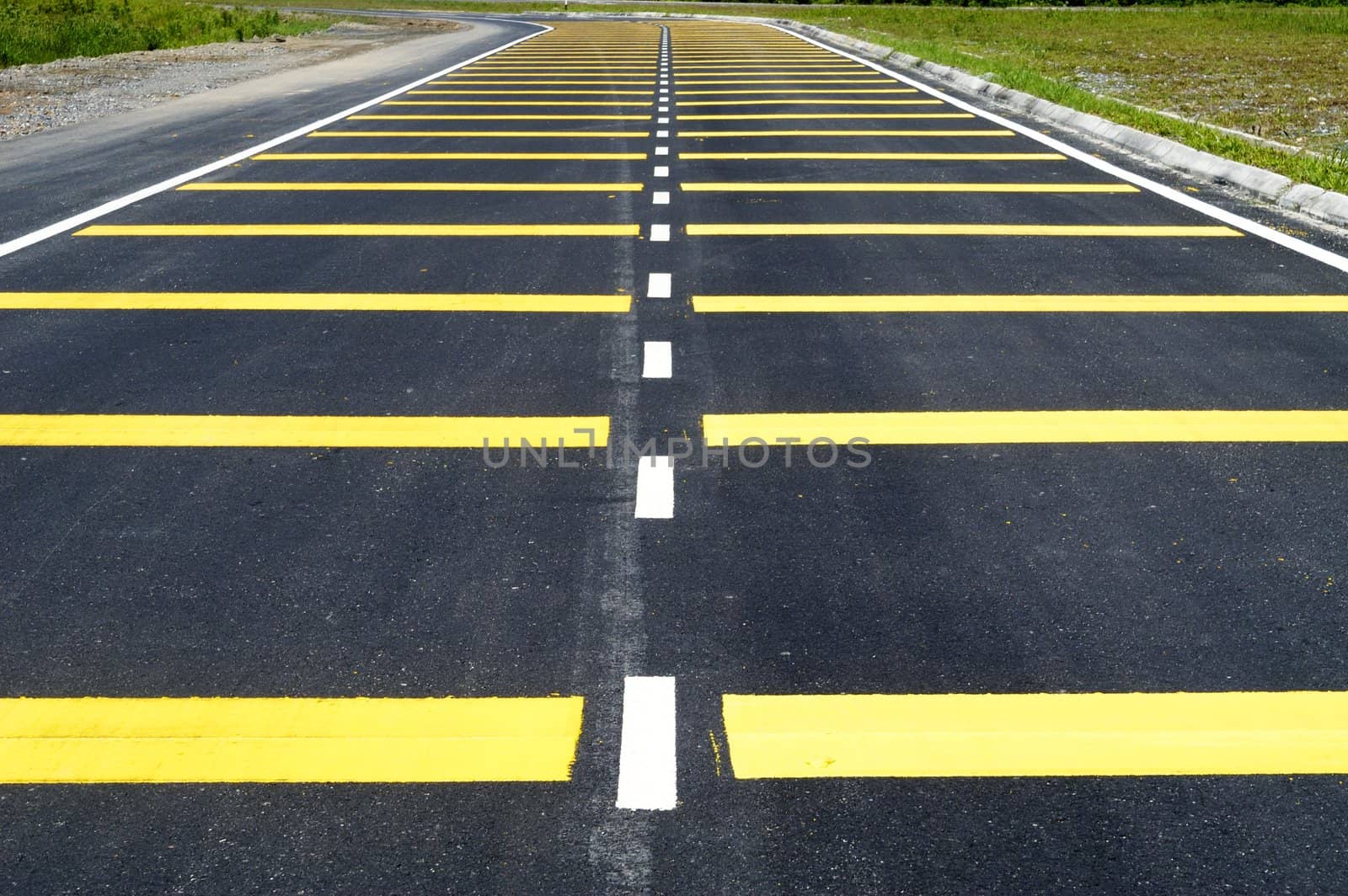 Yellow lines on newly tarred road.