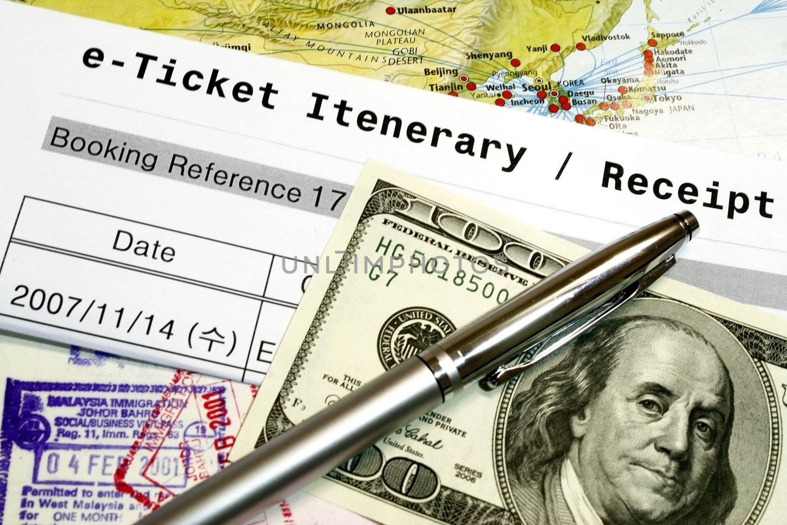 Travel Documents e-ticket itenerary passport and dollar - concept for travel.