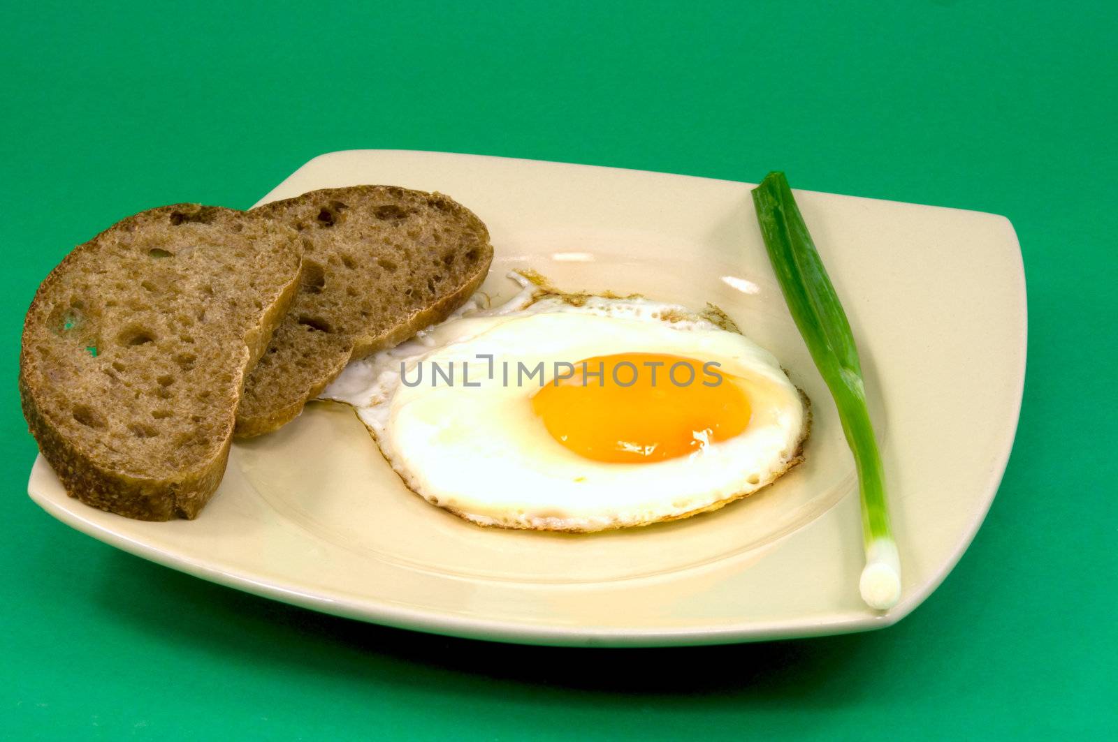 
fried eggs from one egg with bread and green onion