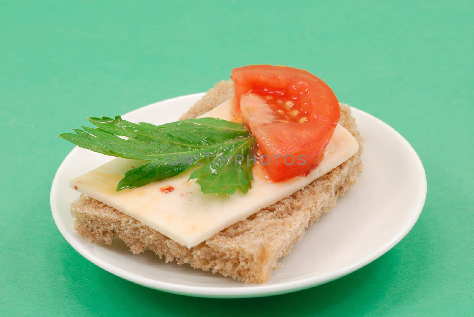
Buterbrob with Mexican cheese, slice tomatoes and green leaves of parsley