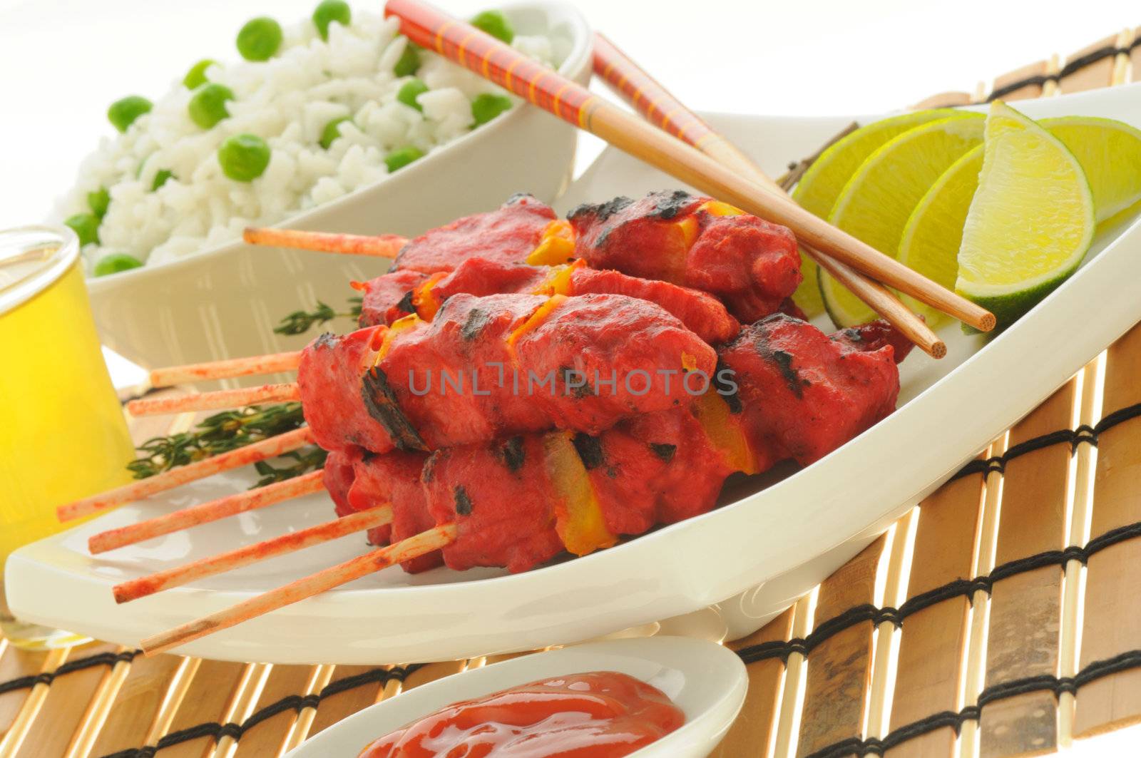 Delicious grilled chicken skewers served with rice.