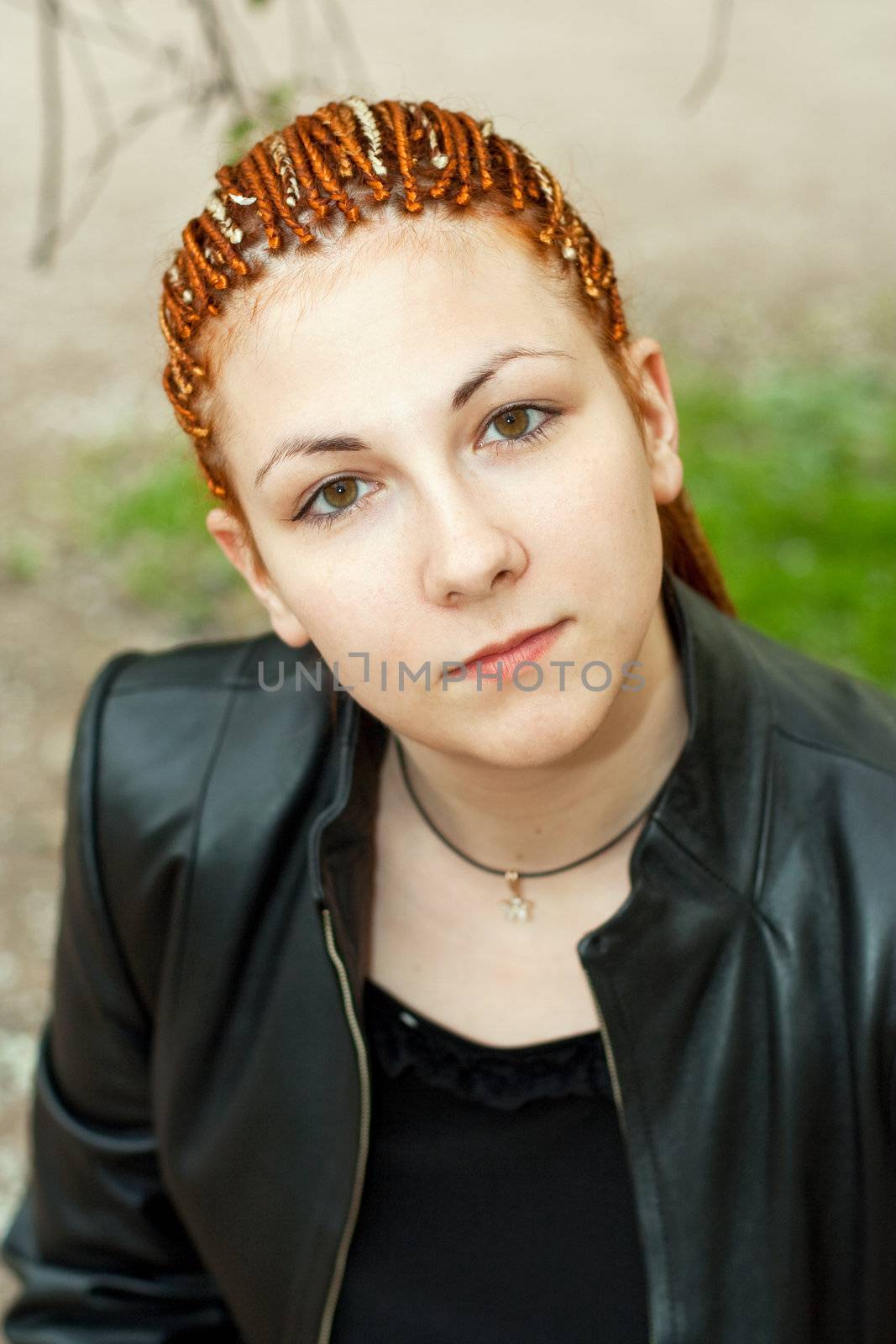 beautiful emotional girl with african braids looking directly at camera