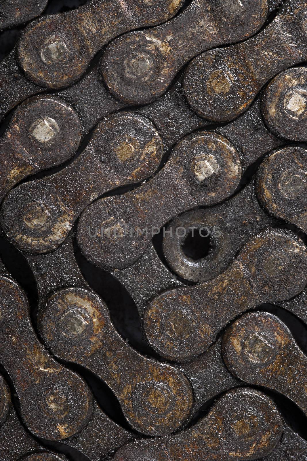 Macro image of a dirty oily bicycle chain as a background.
