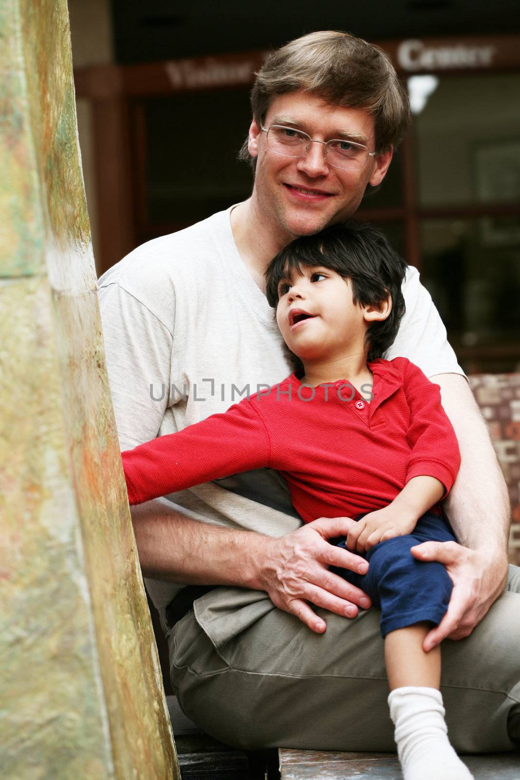 Father happily spending time with his toddler son;