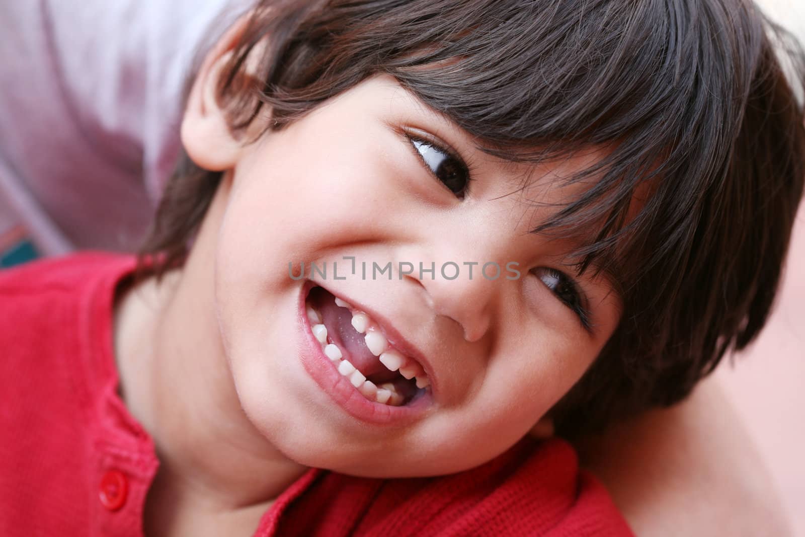 Happy little boy smiling, part Asian - Caucasian descent