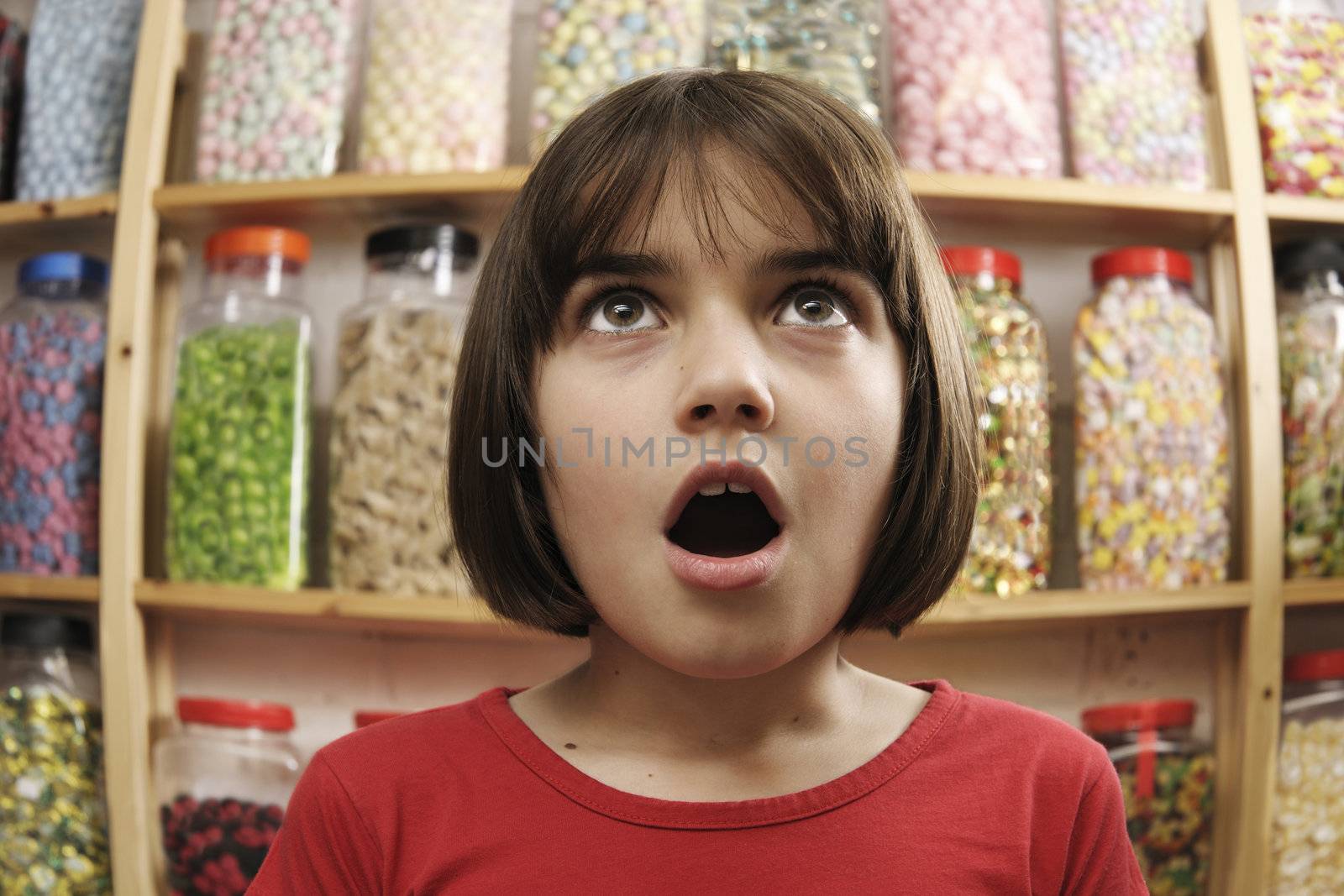 child looking in awe at sweets