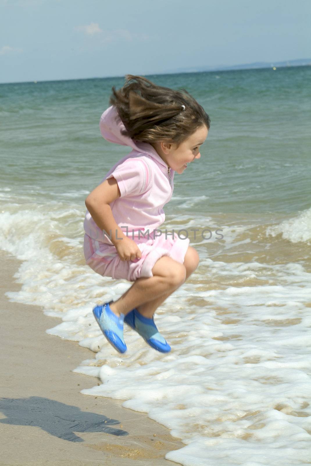 child playing by waters edge