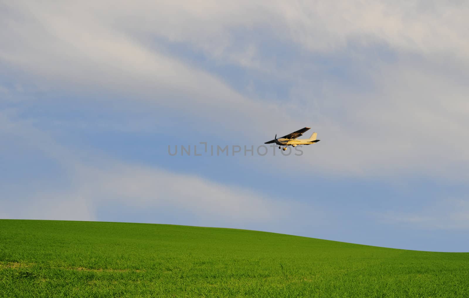 plane flying over farmland