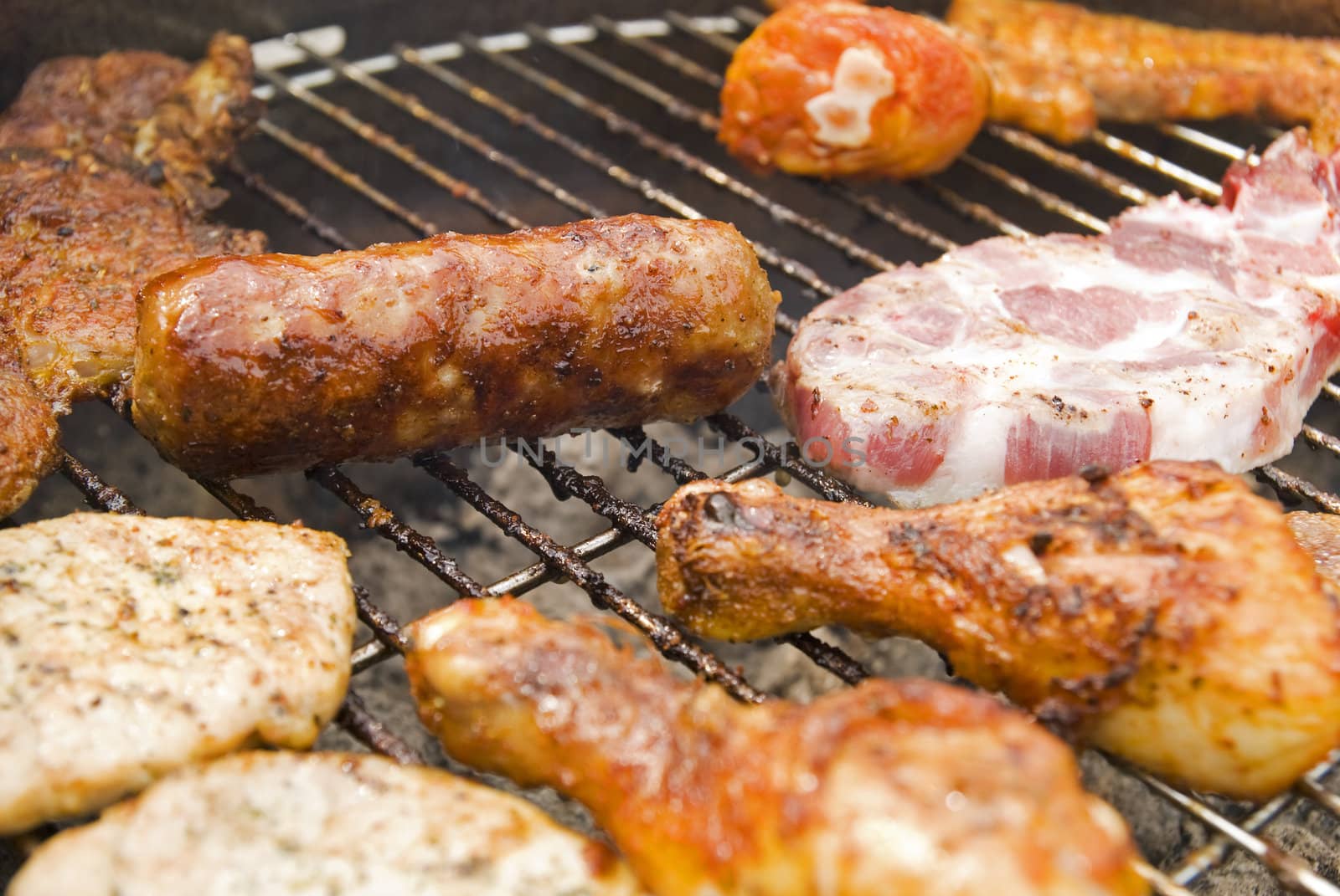 Sausages, beef and other meat on a barbecue