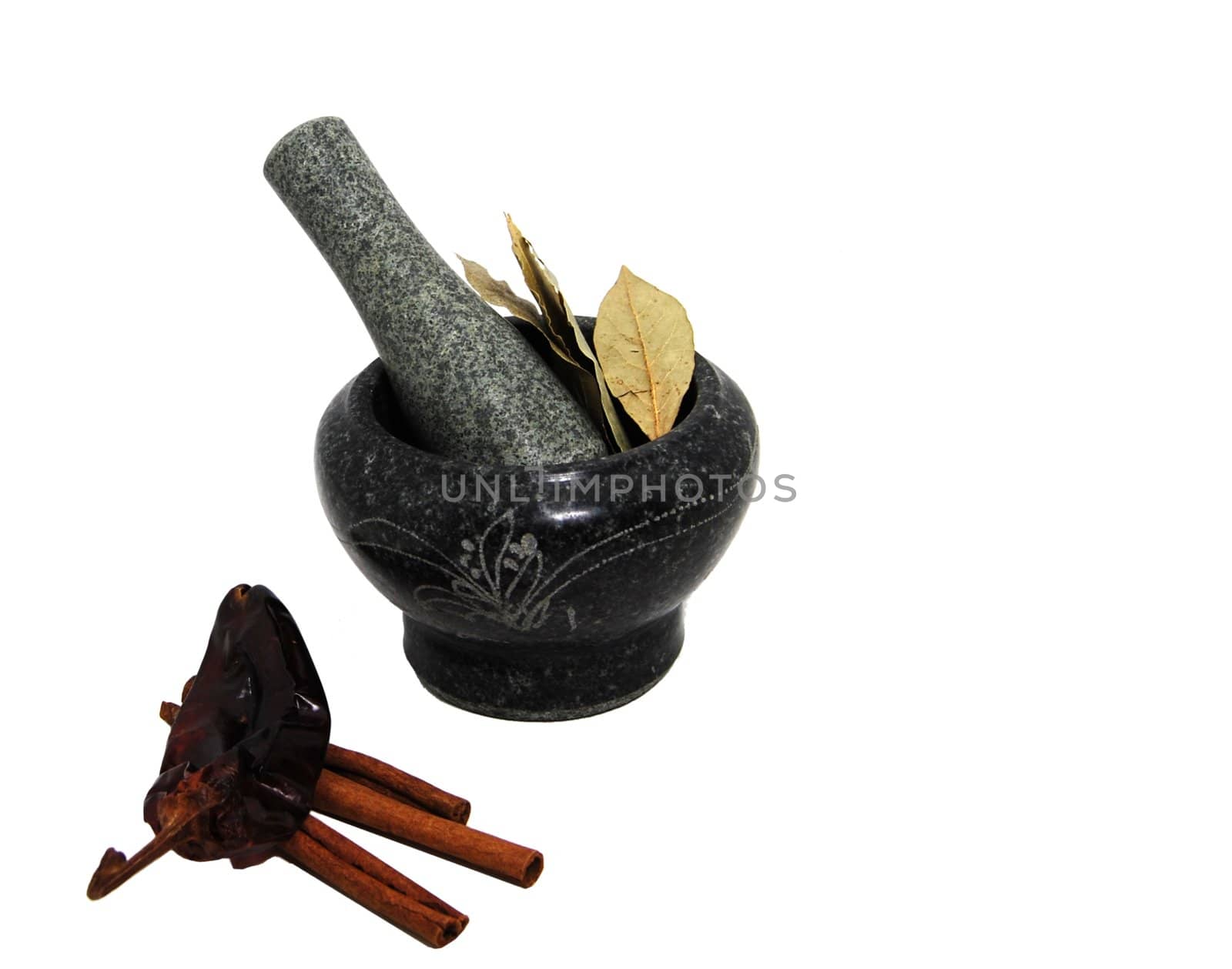 Bay leaves nestled in a stone mortar and pestle set.