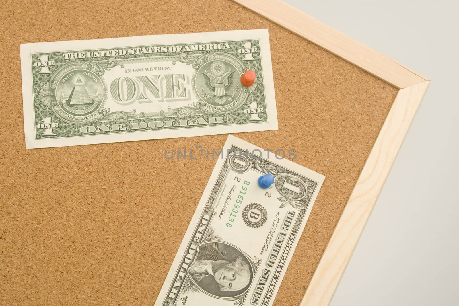 One dollar bills on a cork board with copy space. Money concept 