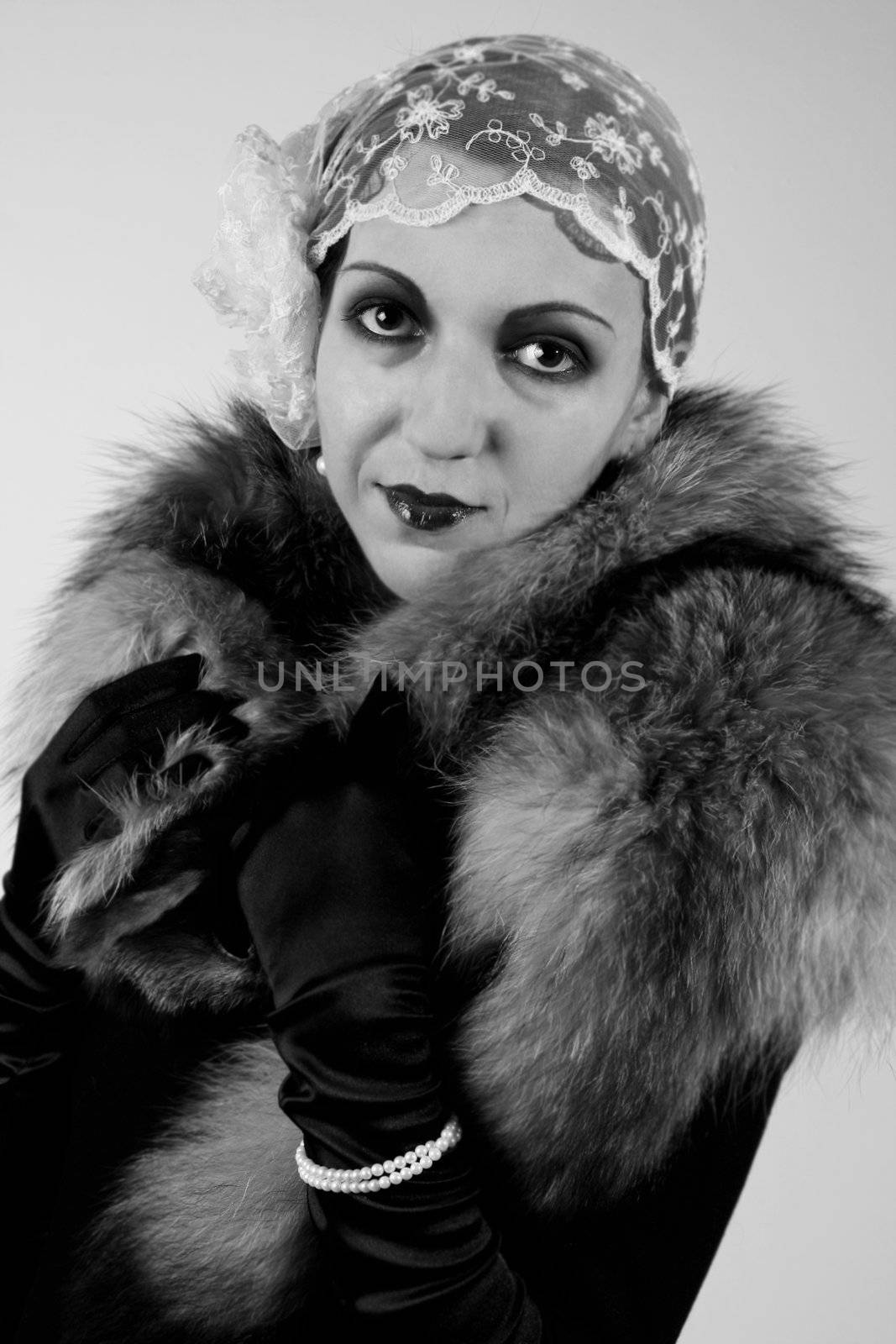 Retro styled fashion portrait of a young woman. Clothing and make-up in twenties style.