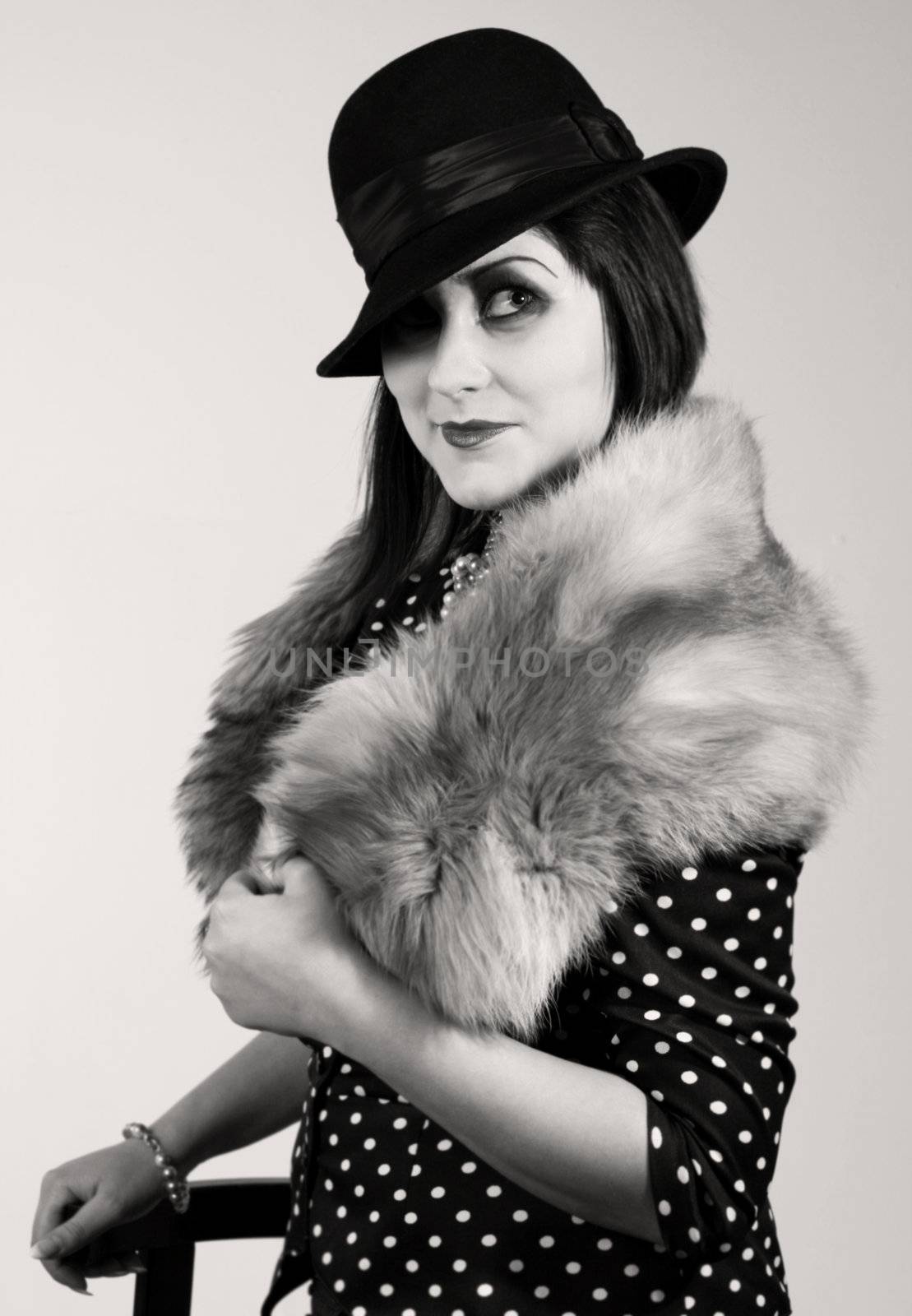 Retro styled fashion portrait of a young woman. Clothing and make-up in twenties style.