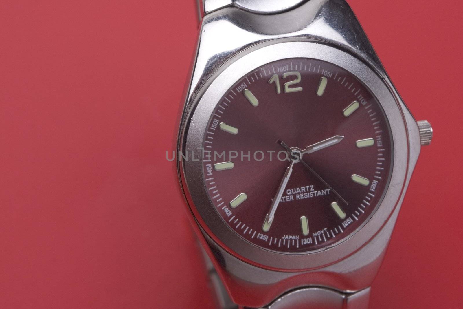 Close up of a men sport watch on a red background