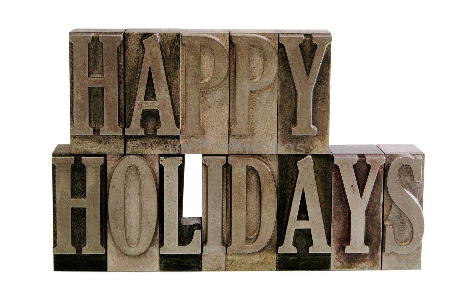 the phrase 'Happy Holidays' in letterpress metal letters isolated on white