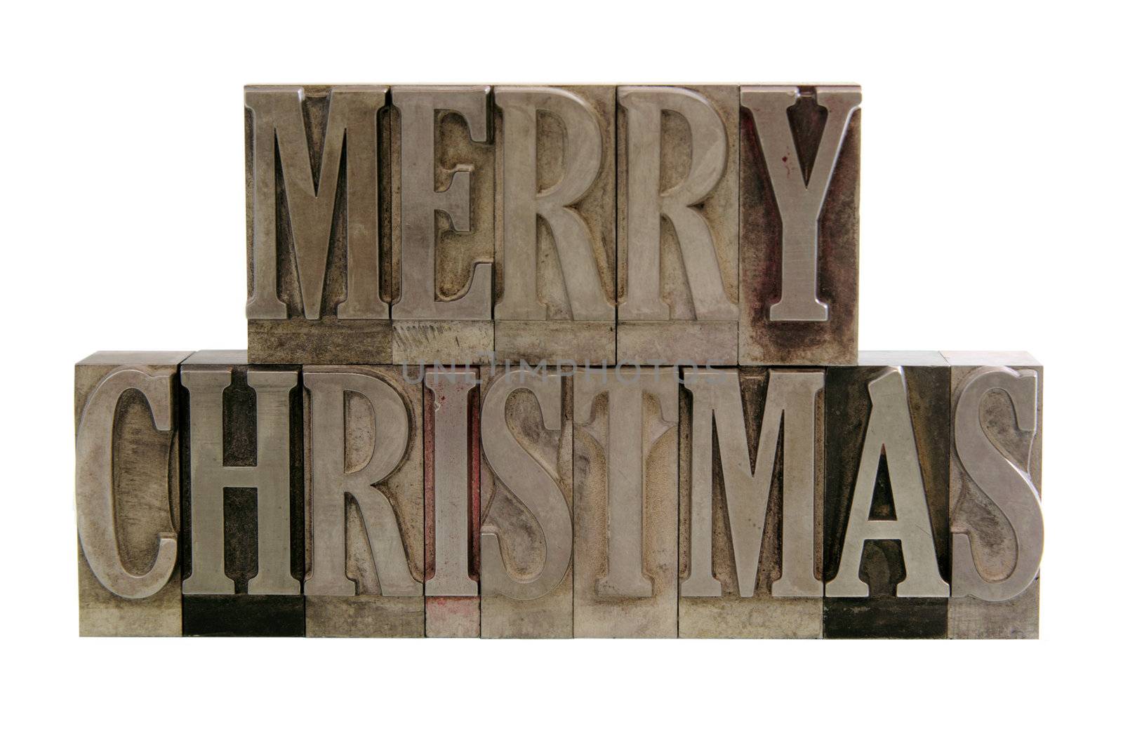 the phrase 'merry christmas' in letterpress metal letters isolated on white