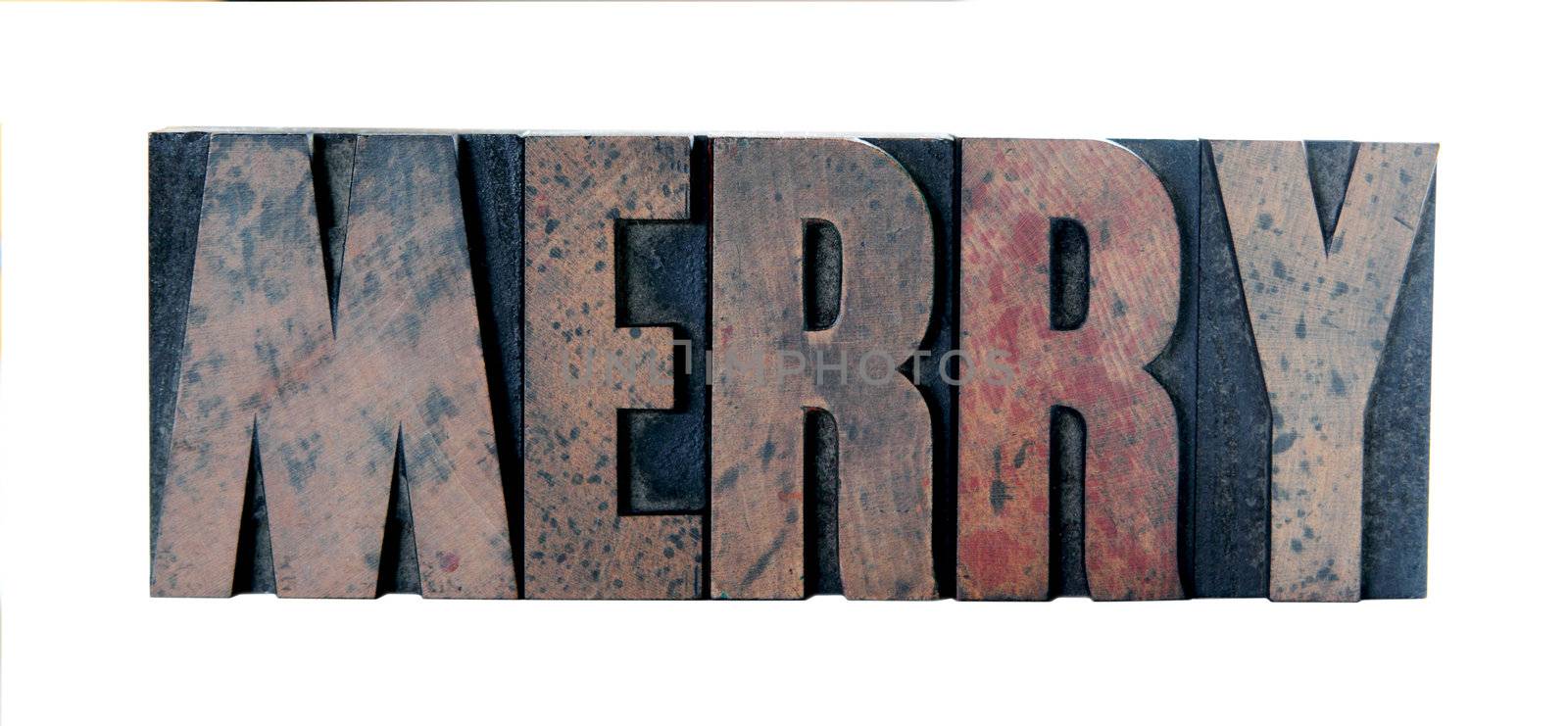 old, ink-stained wood letters spell out the word 'merry' in all caps isolated on white