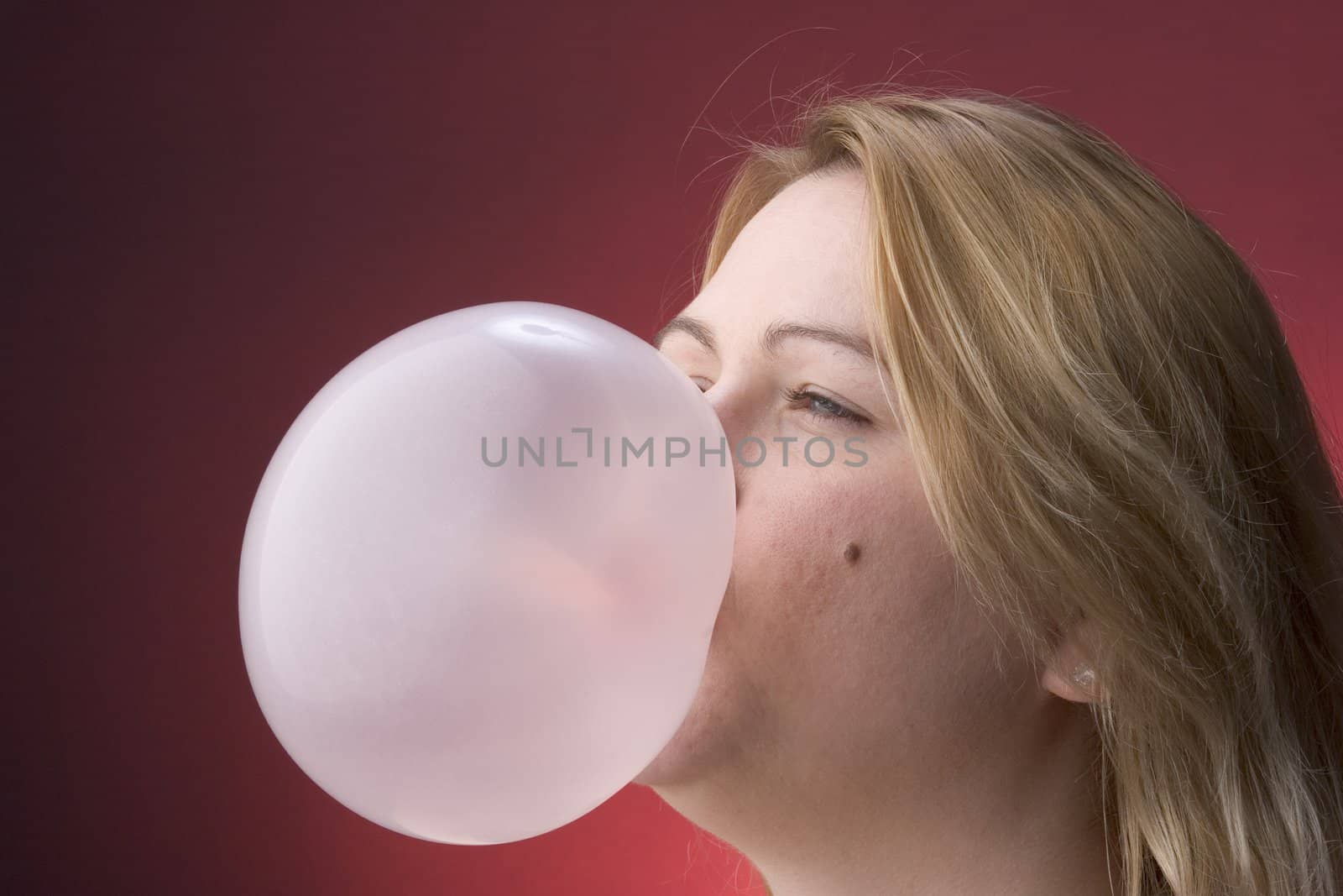 Profile of a women blowing a bubble