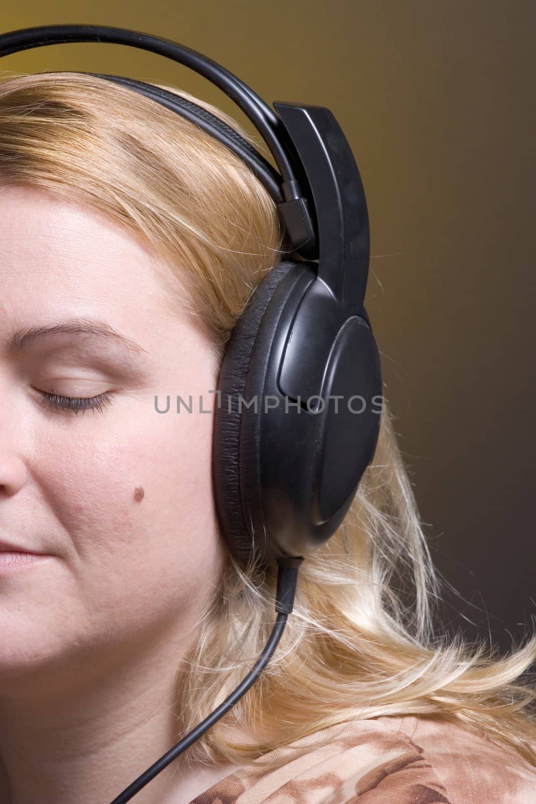 Women listing to relaxing music with her eyes close