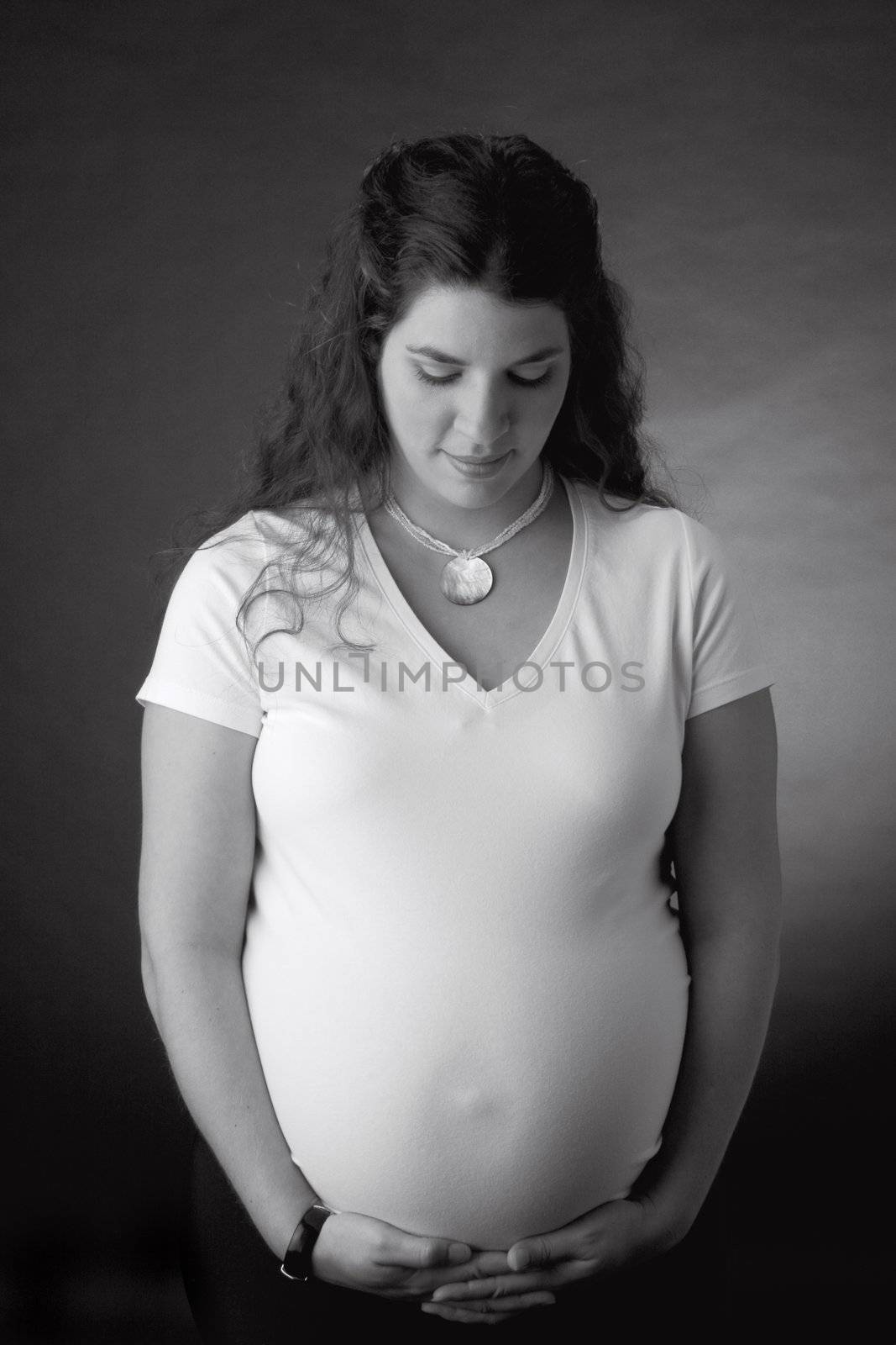 Women pregnant looking down by mypstudio