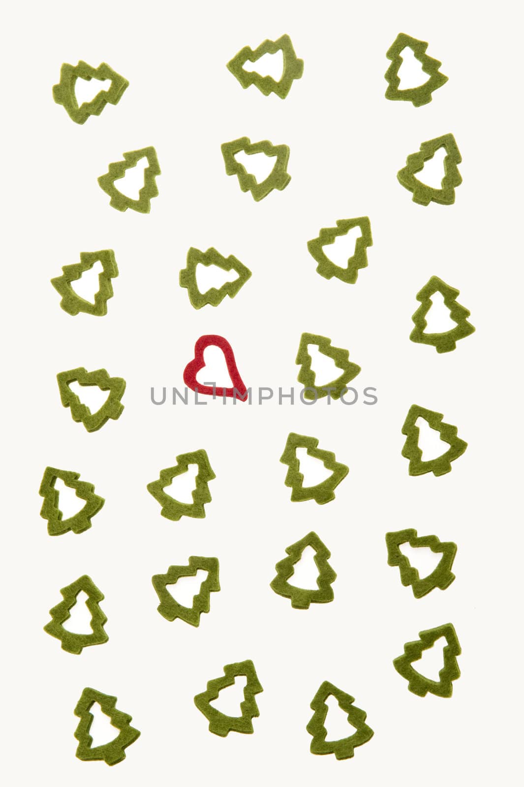 Ornamental heart between fir-trees on white background representing Christmas.
