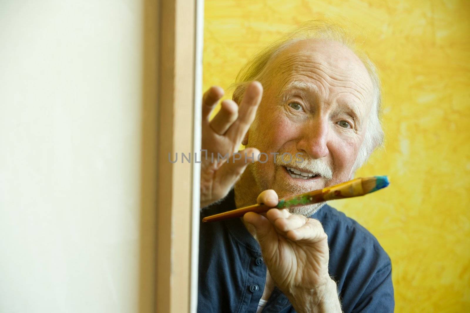 Elderly painter working on a large canvas