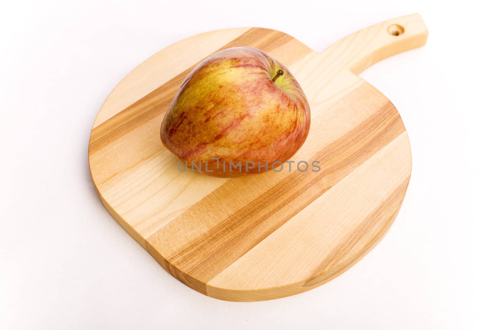 Red apple over a wooden apple shaped potstand