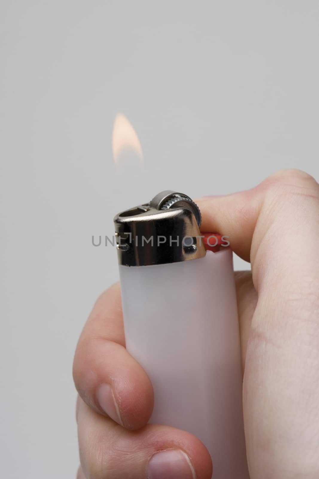 Women hand holding a white lighter with flame on white background