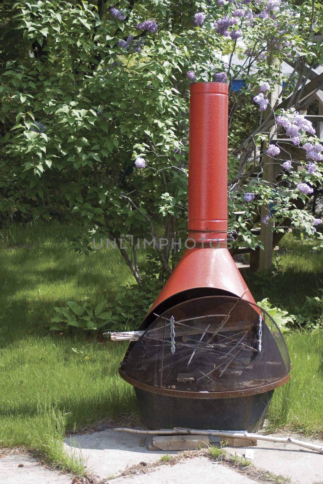 Metal outdoor fire place with lilac background
