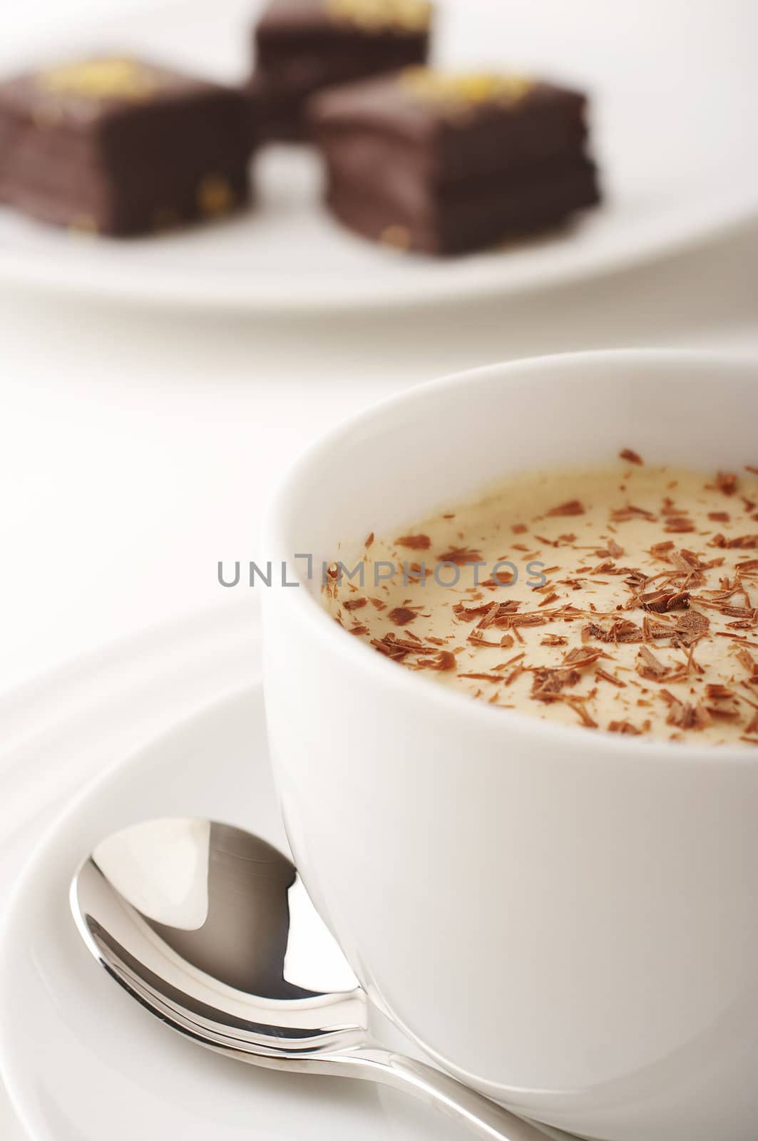 Coffee cup with cream and chocolate cakes