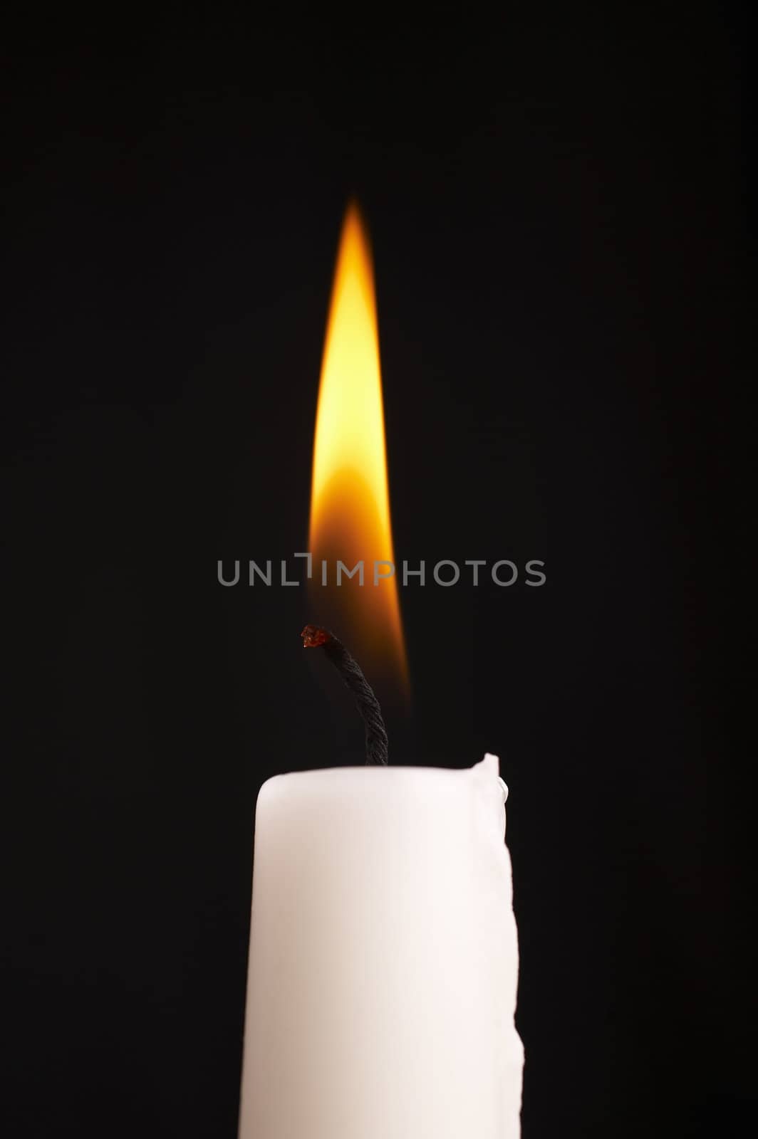 Isolated candle stick with light over a black background