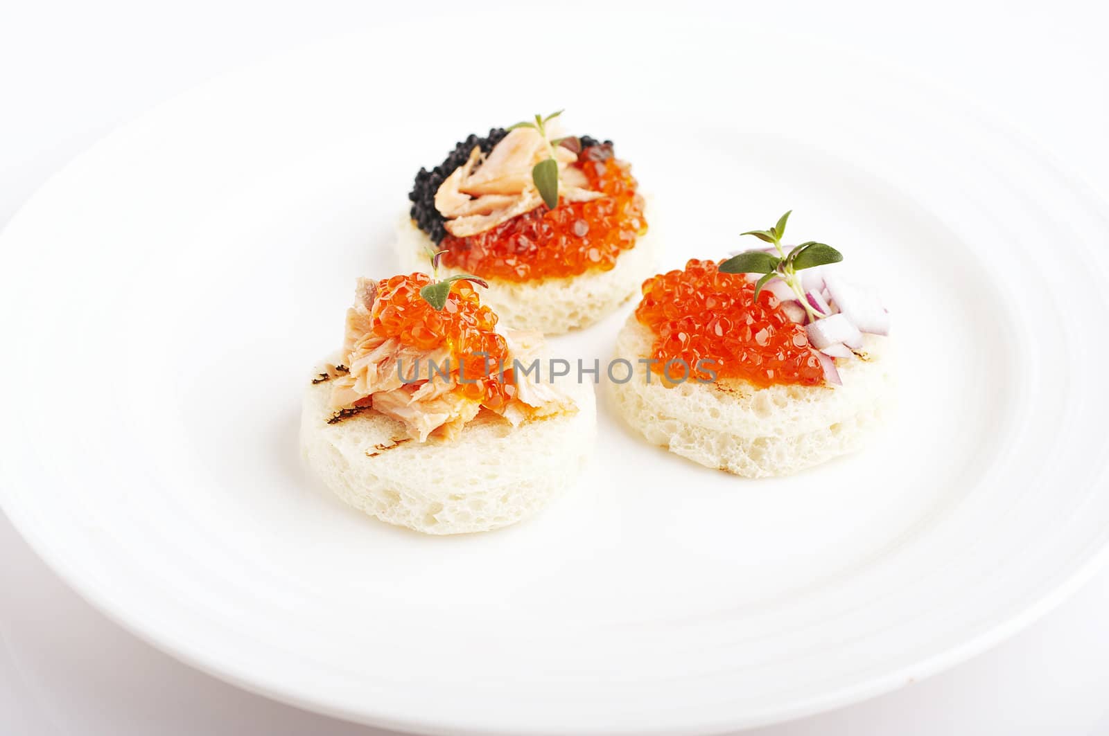 Salmon roe, sea weed roe, smoked salmon and onion on the toast