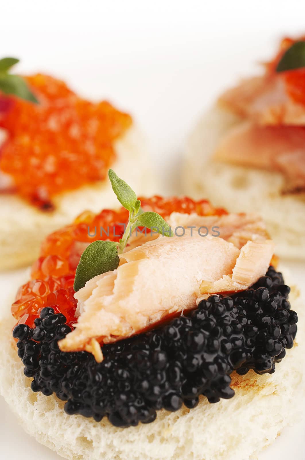 Salmon roe, sea weed roe, smoked salmon and onion on the toasts