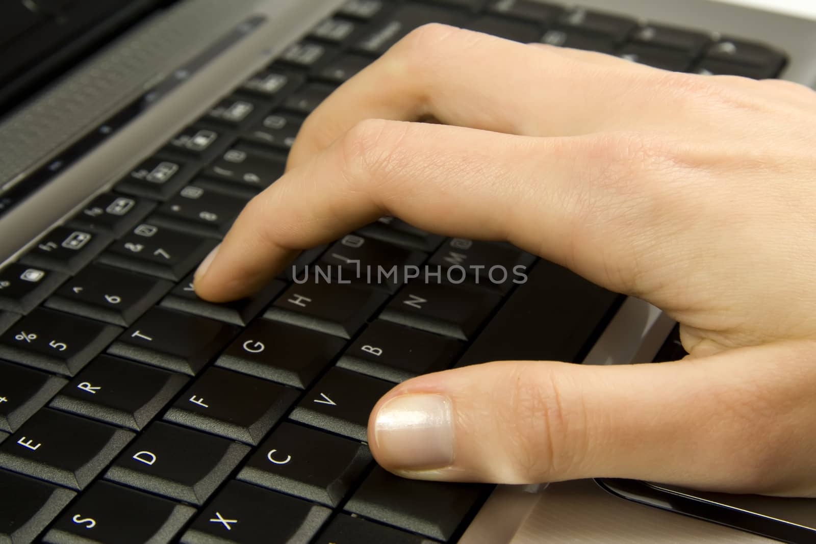 Human hand on black laptop keyboard