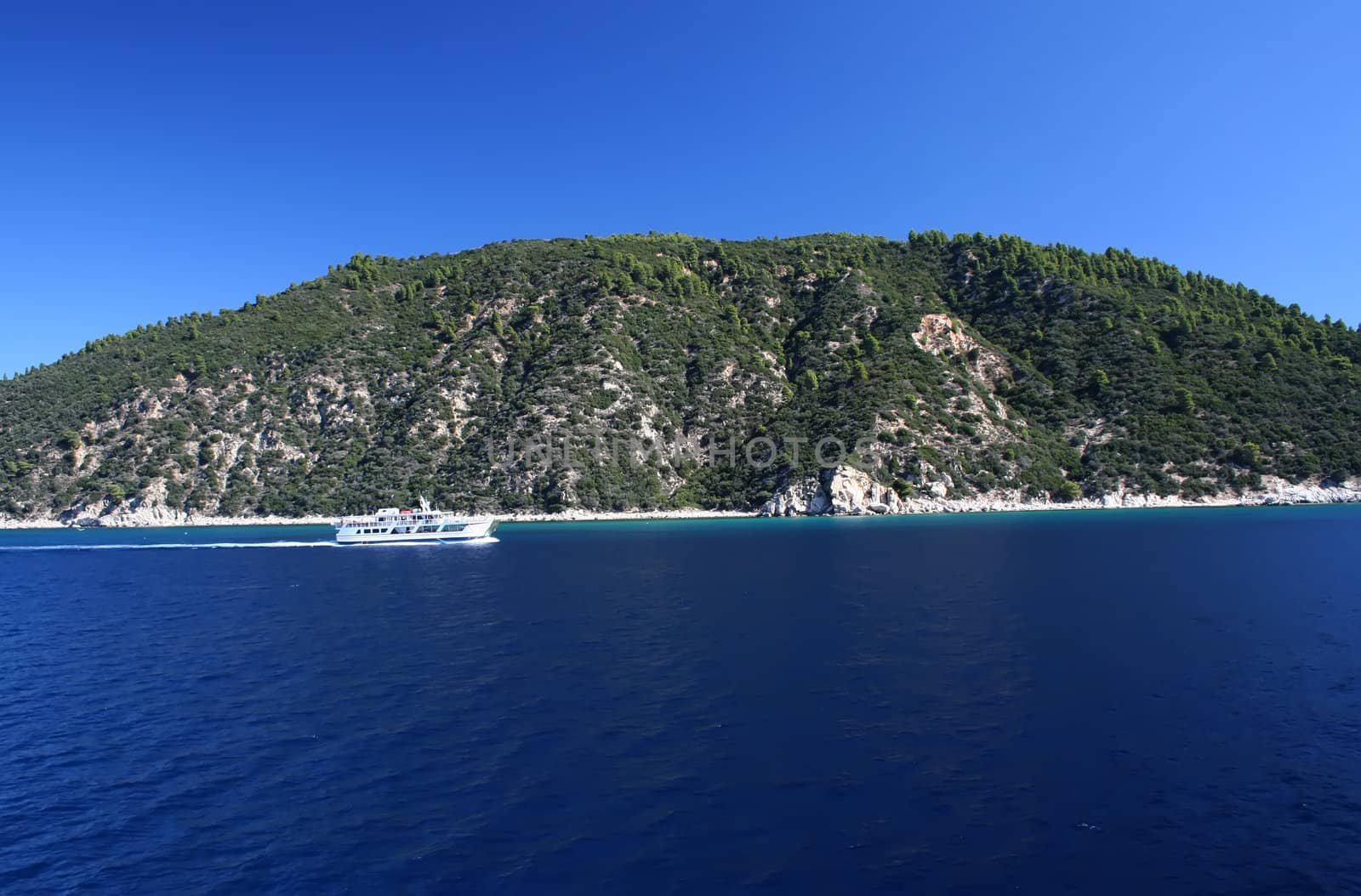 Tropical blue sea landscape with white ferry