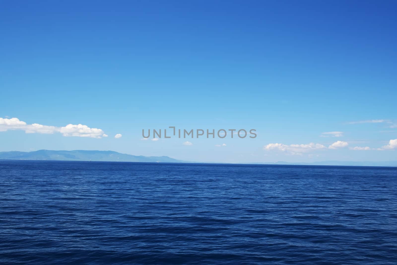 Perfect Blue Sea with coast on horizon