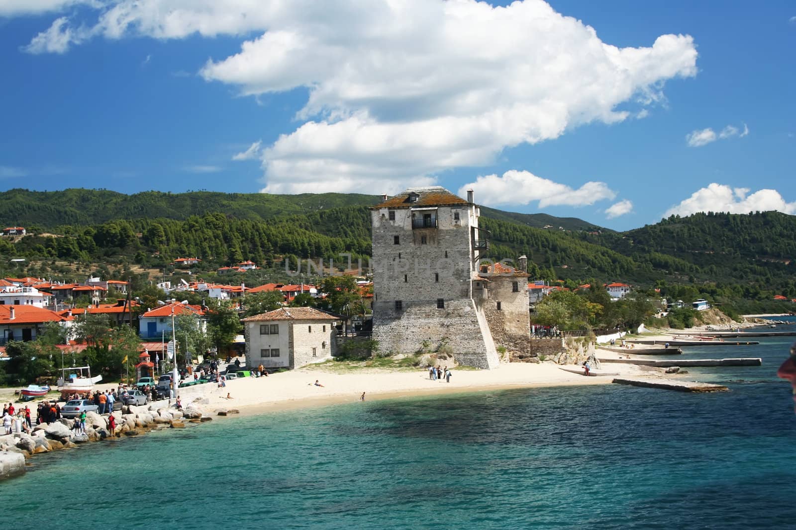 Small city coast with tower over blu sky