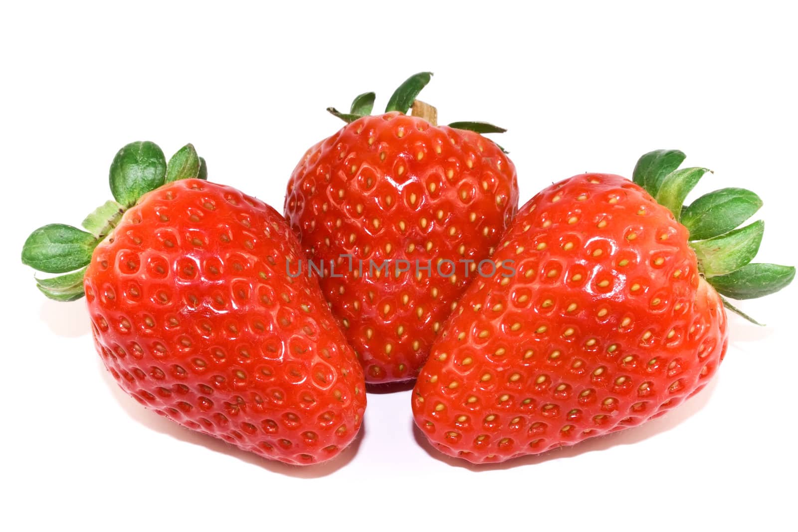 Three strawberries closeup isolated on white