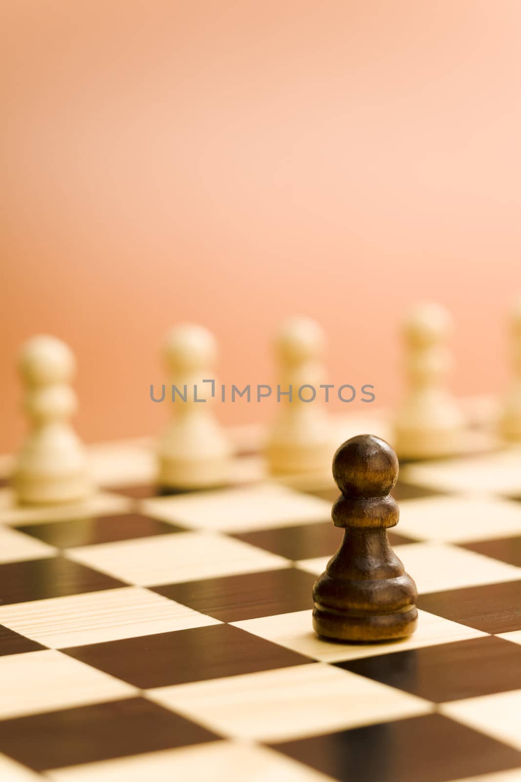 One black soldier against white on chess board.