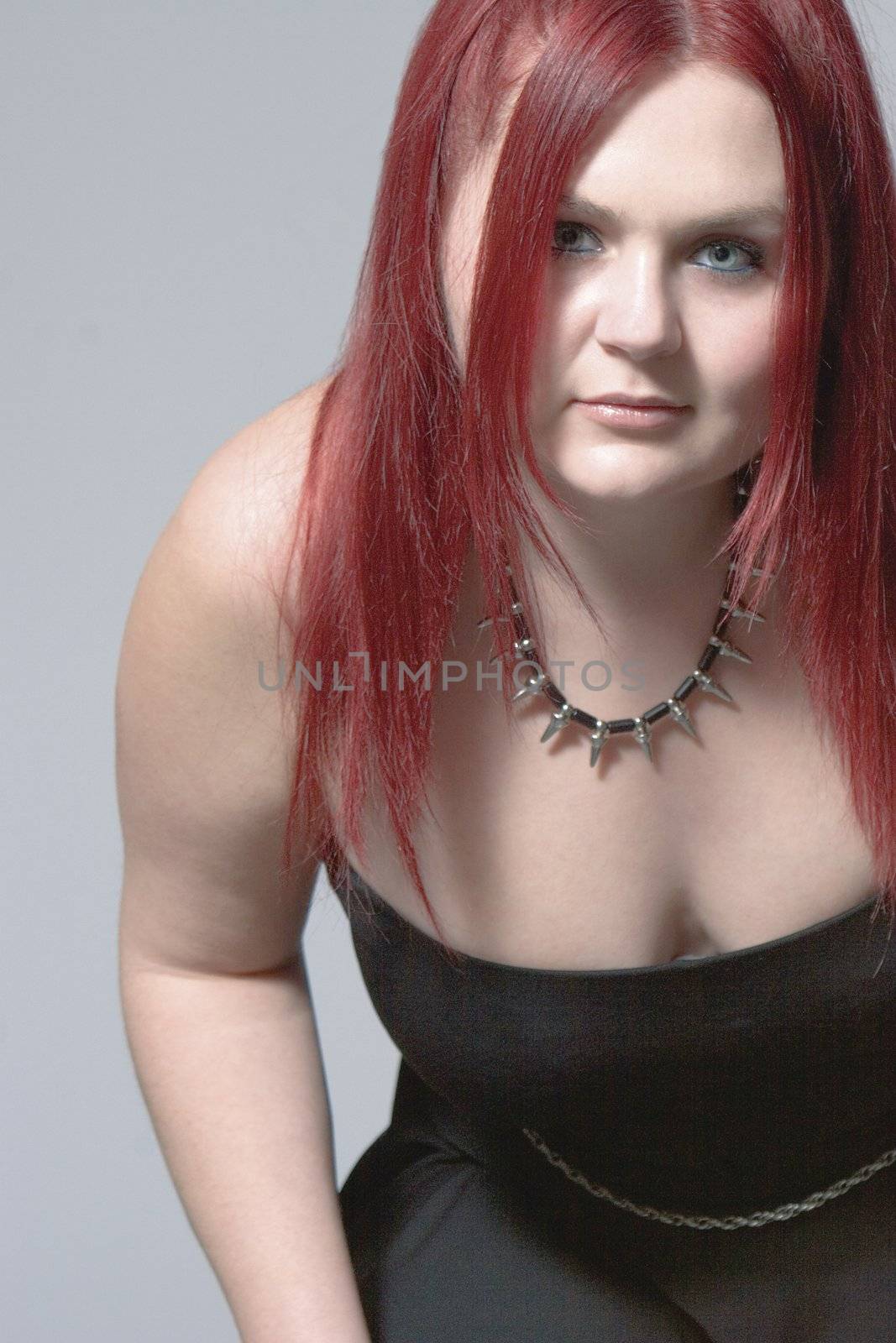 Red hair female model with cleavage and goth look