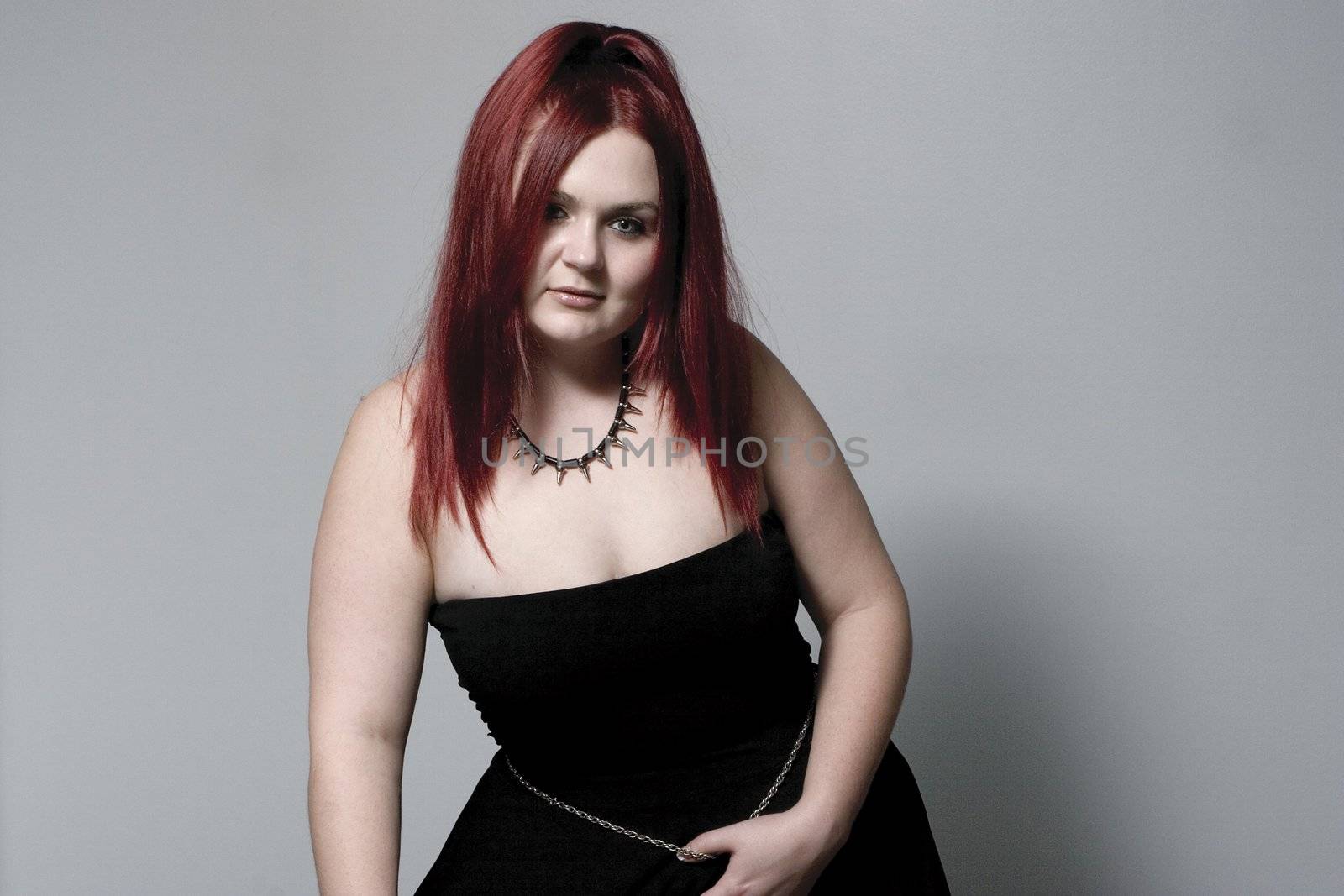 Red hair female model looking down with goth look